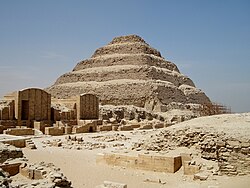 Ruines du complexe funéraire du roi Djéser à Saqqarah, dominées par sa pyramide à degrés, XXVIIe siècle.