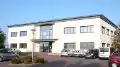 Photo de la façade du bâtiment à deux étages hébergeant les locaux actuels d'ADCIS